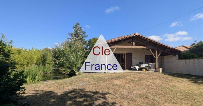 Charming and Cosy House with Bridge over Pond in Garden