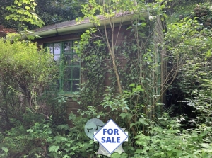 Wooden Chalet on Land Bordered by a River